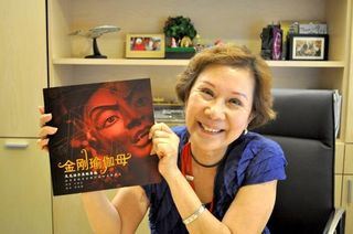 Kechara House President Dato May Phng holding a copy of the Chinese Vajrayogini book. 