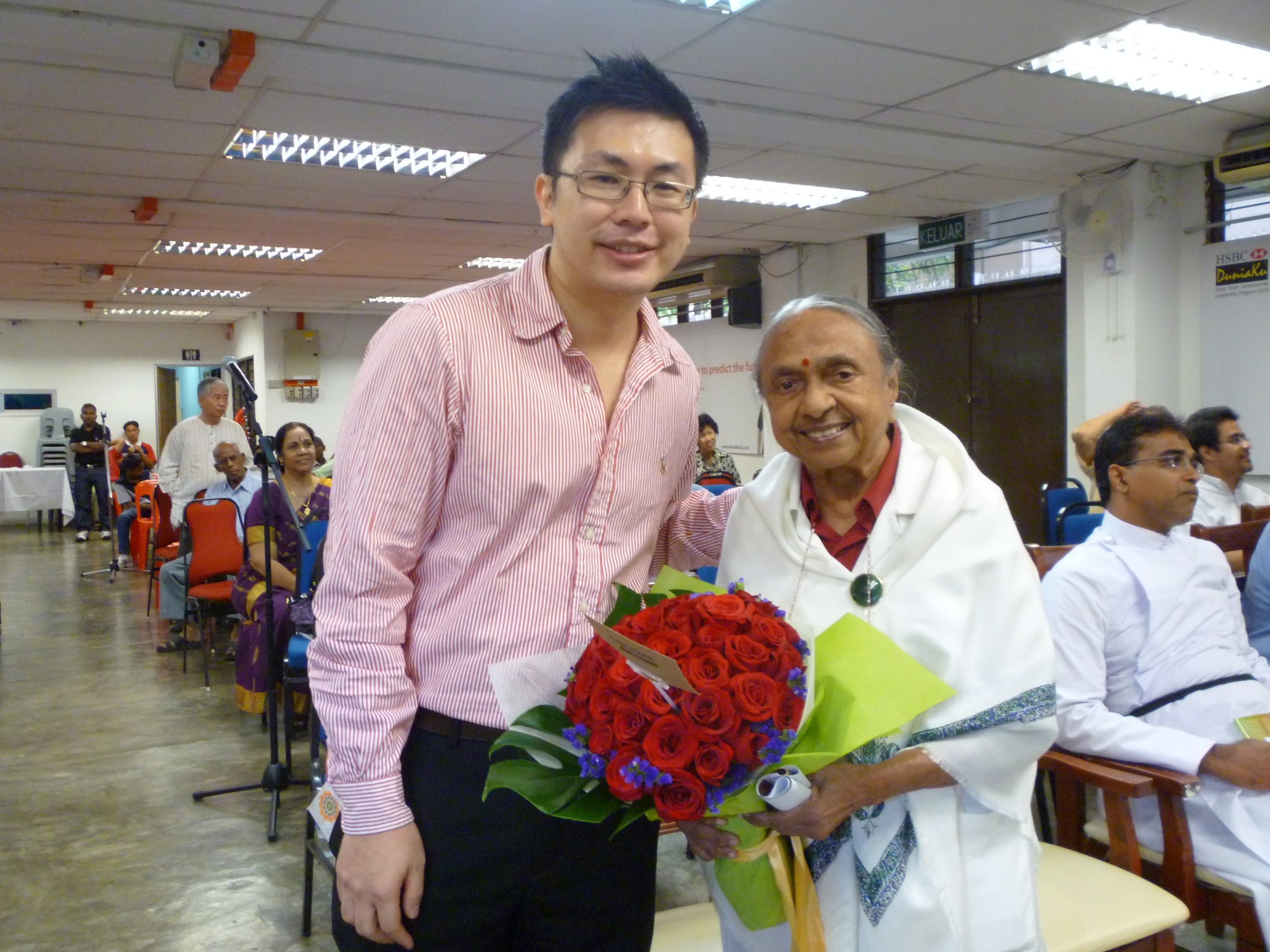 Presenting a bouquet of roses on behalf of Rinpoche to Mother Mangalam